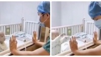 Bé trai nhiễm virus corona yếu ớt đòi bế trong phòng cách ly, bố bất lực nhìn con qua cửa kính